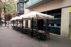 Quatro guarda-sóis Indus D no terraço de um restaurante.