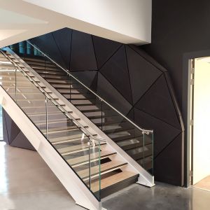 Triangular paneled wall next to the staircase.